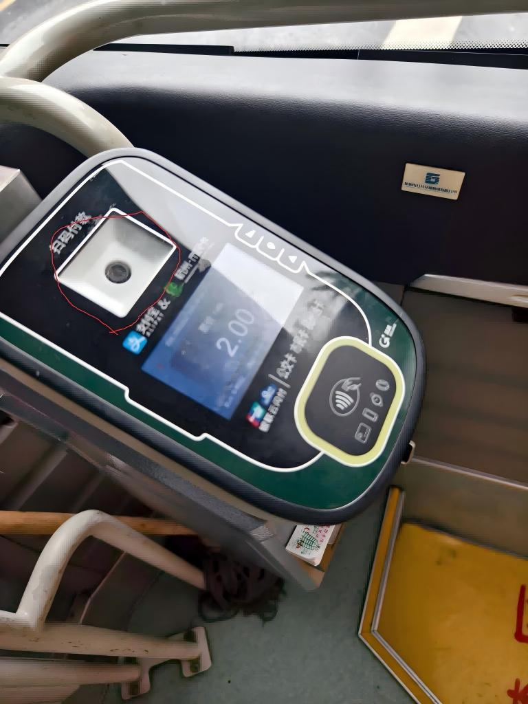 Bus ticket machine with QR scanner next to the driver